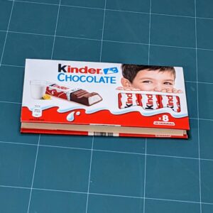 Handmade notebook with upcycled cover of Kinder chocolate package binded by an artist Žilvinas Bražukas Production. Rankų darbo užrašinė su pernaudota Kinder Šokolado pakuote
