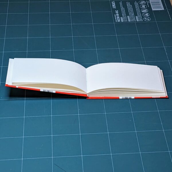 Handmade notebook with upcycled cover of Kinder chocolate package binded by an artist Žilvinas Bražukas Production. Rankų darbo užrašinė su pernaudota Kinder Šokolado pakuote